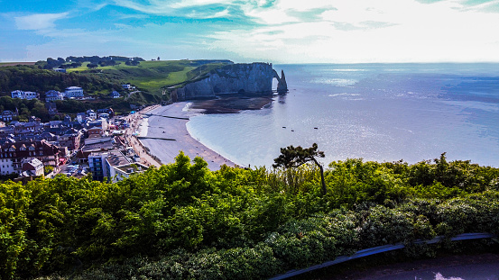 Panoramof bay of Etretat town and  Falaise d'Avaln   - famous cliff   from hill  where Chapelle Notre-Dame-de-la-Garde. Amazing beauty of nature in popular place in touristic Normandy in May (and summer)