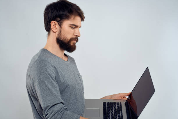 istock Emotional man holding a laptop success modern style work light background 2141542625
