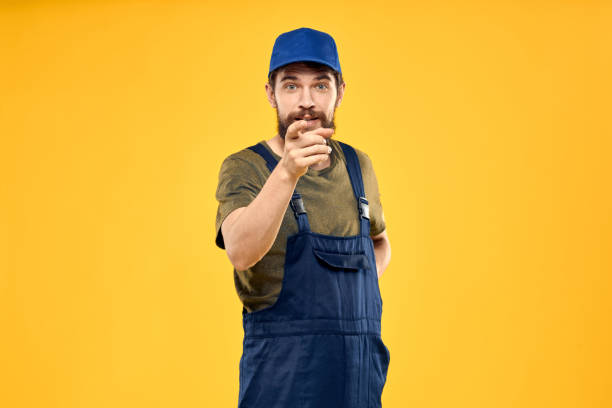 istock man in work uniform rendering service forklift work lifestyle yellow background 2141549466