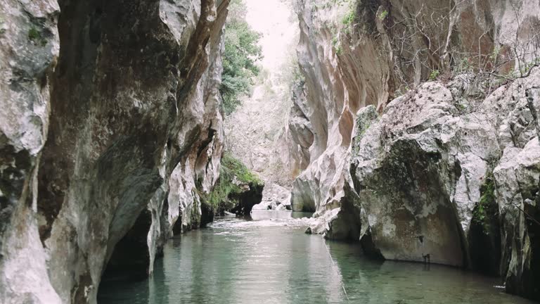 Discover a hidden narrow canyon, emerald waters flowing through. Perfect for those seeking serene canyon, emerald scenes. Unique canyon, emerald water captures tranquility