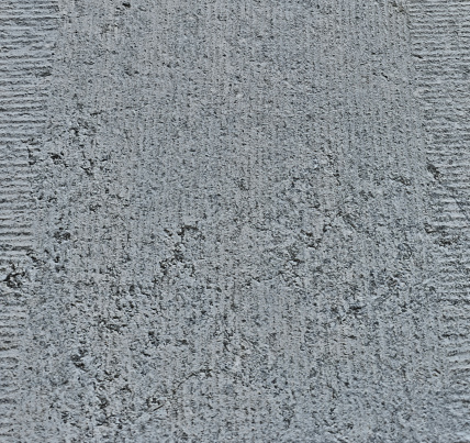 Texture of gray heterogeneous stone with potholes. uneven surface, rough surface.