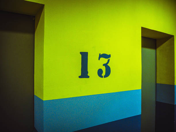 istock thirteen floor with number on yellow wall near lift, elevator 2141582668