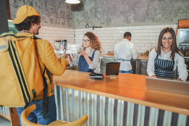 istock Male delivery worker picking up order at the bar 2141586385