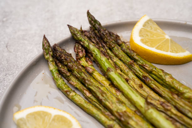 istock Fresh green asparagus on the grey stone background 2141587827