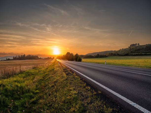 istock Empty asphalt road in a rural landscape at sunset 2141587943