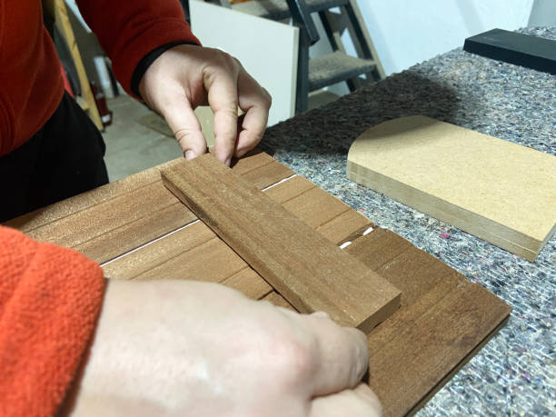 istock Carpenter using glue on wooden furniture part 2141643860