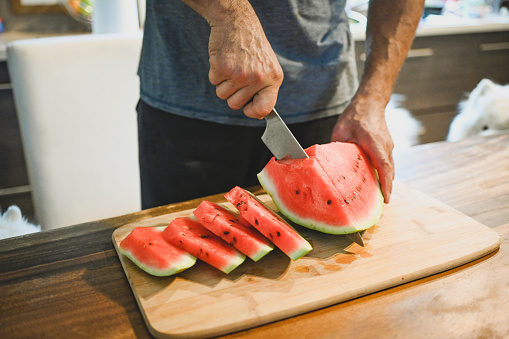 Mature adult man eating watermelon
