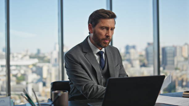 istock Office manager talking computer at desk closeup. Busy middle aged ceo working 2141660401