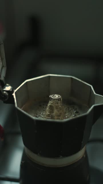 Vertical time-lapse of coffee being brewed in an Italian coffee maker