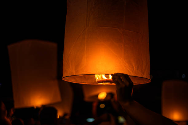 hands release sky lanterns (hot air balloon)Floating sky Lantern in northern Thai traditional new year , Yi Peng Festival and Loy Krathong festival