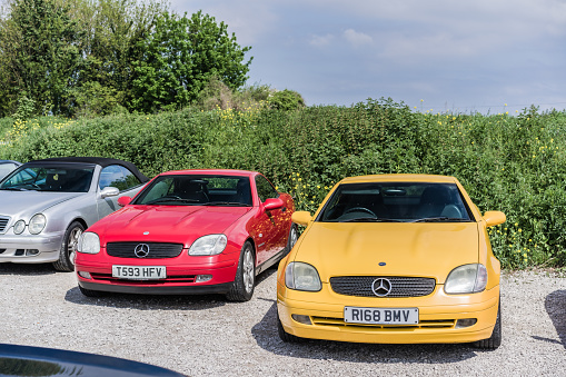 Holywell, Flintshire, Wales, May 13th 2023. Yellow and red Mercedes-Benz SLK at a classic car auction.