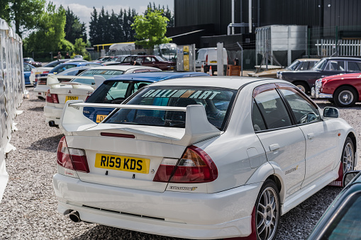 Holywell, Flintshire, Wales, May 13th 2023. View of a white Mitsubishi Lancer EVO V wing at a classic car auction.