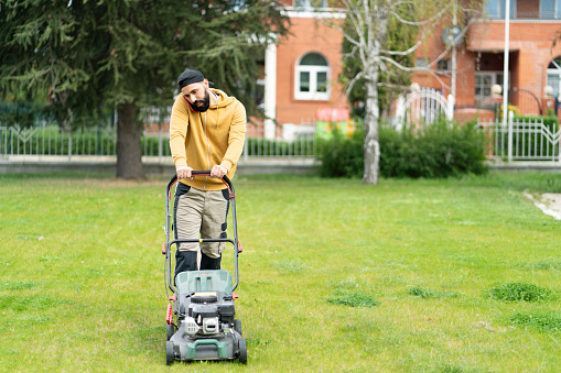 A man is using a lawn mower for professional trimming services