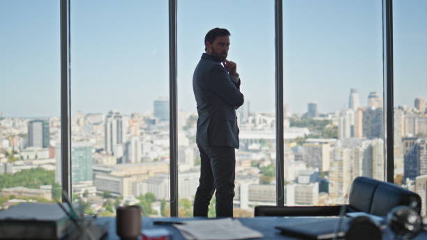istock Executive looking office window at cityscape. Successful manager sign contract 2141689991