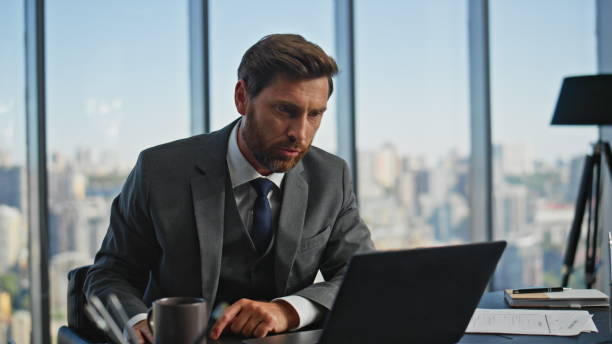 istock Irritated businessman talking laptop call in panoramic office. Angry man arguing 2141701078