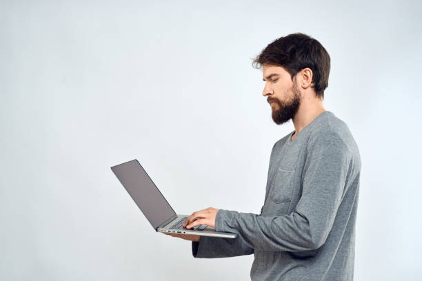 istock A man in a gray sweater with a laptop hands lifestyle technology communication internet work 2141721680
