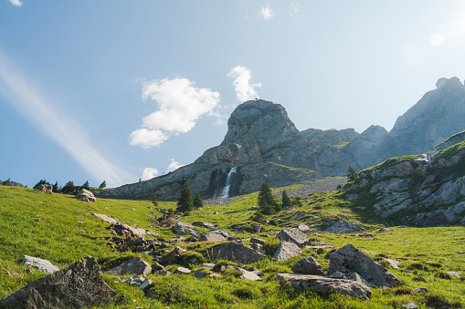 Scenic tranquil view of  waterfall in Swiss alps in summer