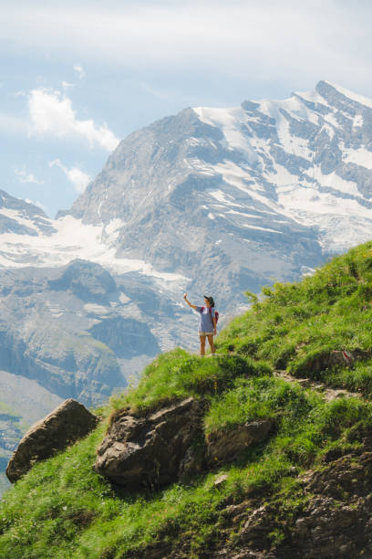 istock Woman using smartphone while hiking  in Swiss Alps 2141737721