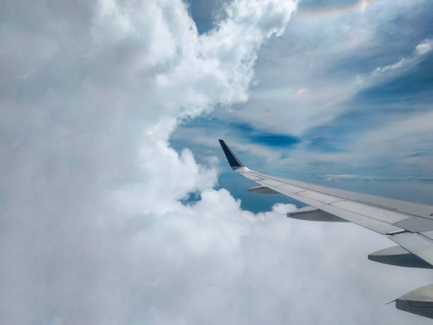 Peer through the window of your airborne vessel and witness nature's masterpiece unfold as clouds stretch across the horizon, painting the sky with ethereal strokes.