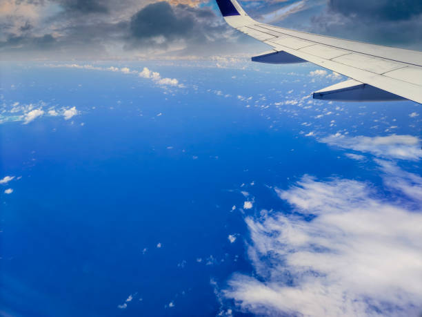 Peer through the window of your airborne vessel and witness nature's masterpiece unfold as clouds stretch across the horizon, painting the sky with ethereal strokes.