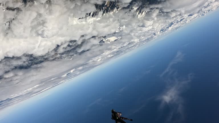 Free fall jumpers soar above mountain landscape