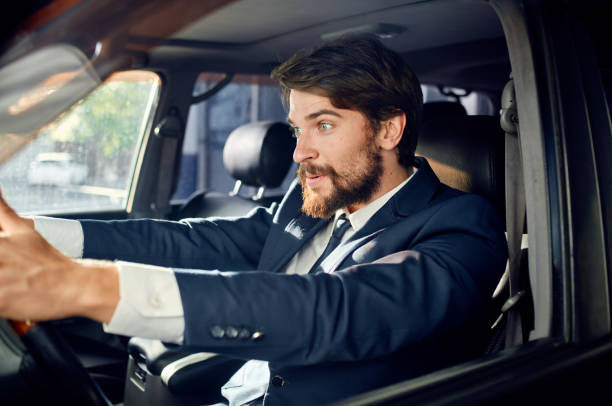 istock rich man in suit driving a car trip fun lifestyle 2141783676