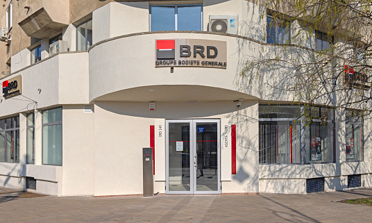 Craiova, Romania - March 16, 2024: Entrance to Brd Groupe Societe Generale Bank Building at Mihai Viteazul Street Sunny Day.