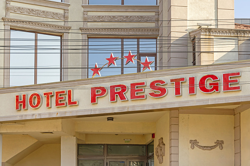 Craiova, Romania - March 16, 2024: Red Sign Four Star Hotel Prestige Building at Matei Basarab Street in Old Town.