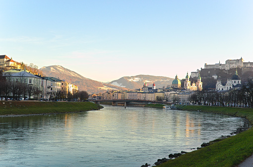 Salzburg, Austria - December 4, 2019: Salzach river and the Hohensalzburg Castle on a beautiful autumn day