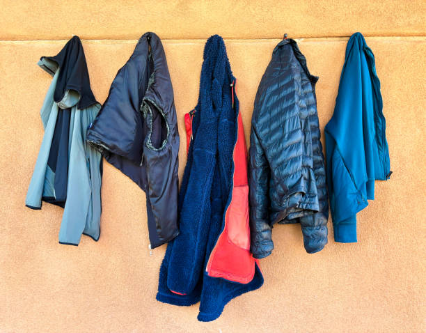 istock Five Blue Jackets/Vests Hanging in a Row 2141824514