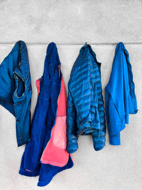 Four Blue Jackets/Vests Hanging in a Row