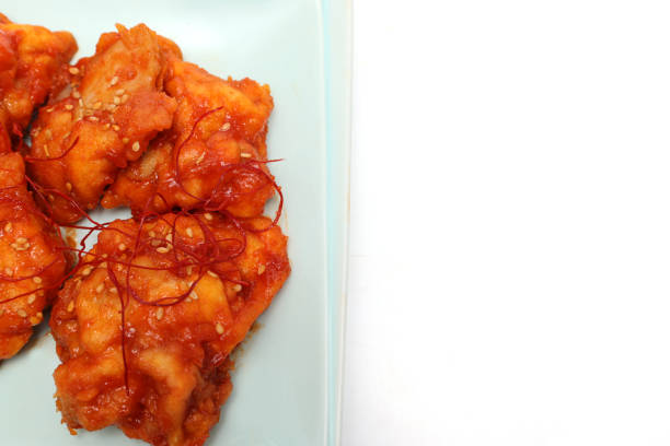 Korean fried chicken on a plate isolated on a wooden background.