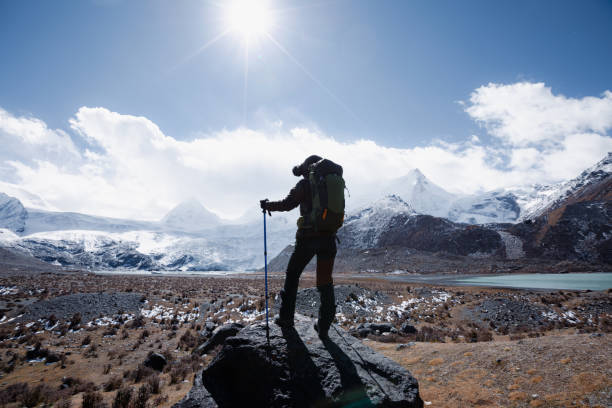 istock Woman backpacker hiking in winter high altitude mountains 2141858769