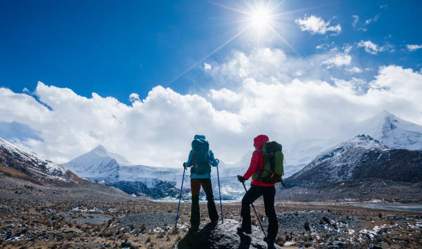istock Two backpackers hiking in high altitude winter mountains 2141858785