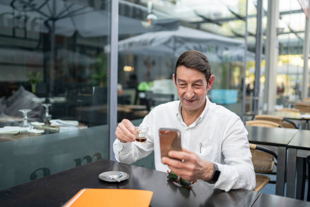 istock Businessman surfing the net in the cafe 2141862480