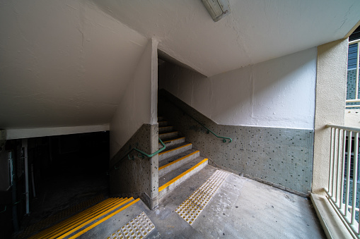 The descent to the basement of the old concrete stairs.