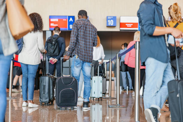 istock A Group Of People Waiting In Queue For A Check-In Luggage 2142015042