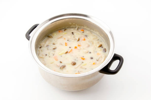A colorful stew cooks gently, blending herbs and vegetables on a warm stove.