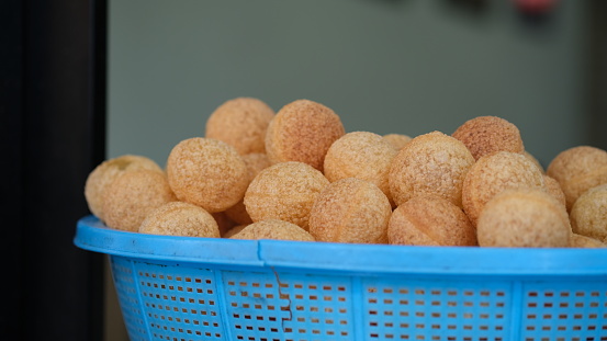 Pani Puri is a deep-fried breaded hollow spherical shell, about an inch (2.5 cm) in diameter, filled with a combination of finely diced potato, onion, peas and chickpea.