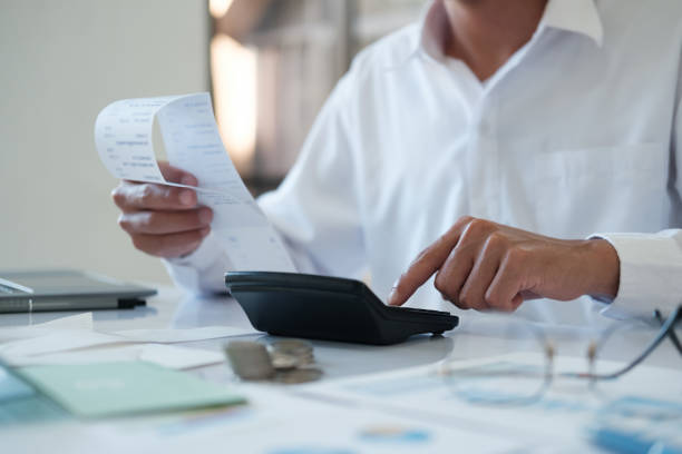 istock Accountants are using calculators to calculate budgets and investments. 2142124371