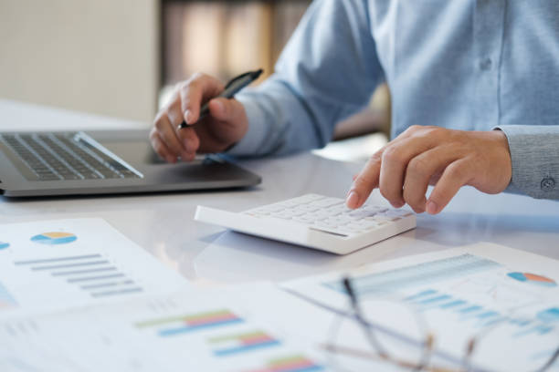 istock Accountants are using calculators to calculate budgets and investments. 2142124890