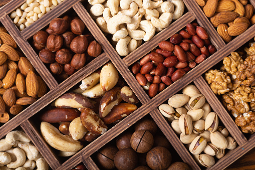 Mix of nuts in box . Healthy vegetarian food background photo