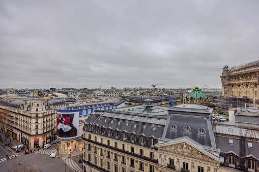 Paris, France - December 26, 2023:  A view of surrounding area of Galeries Lafeyette from its rooftop on a cloudy day.  HDR encoded