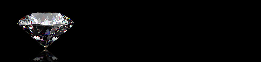 Round cut diamond on black background, wide image