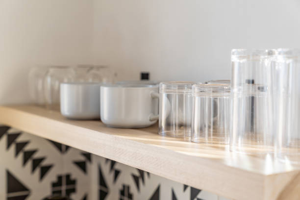 istock Coffee cups glasses on wood floating shelf in modern kitchen 2142239105