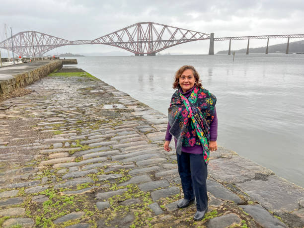 istock Senior Hispanic woman portrait at Forth Bridge Scotland 2142256294