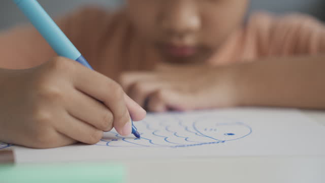 A girl drawing with colored pen