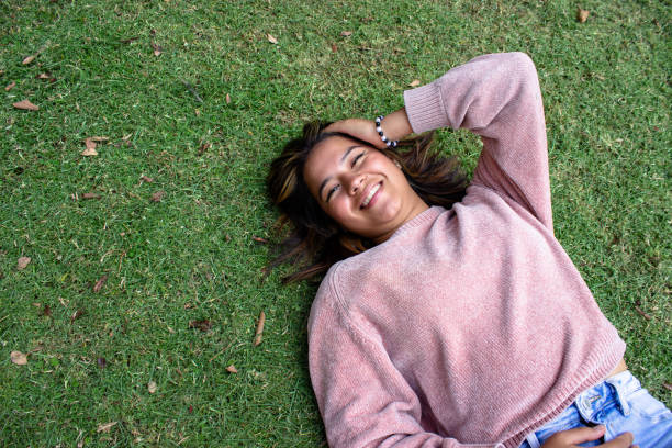 istock Beautiful young woman posing and modeling in a park 2142288078