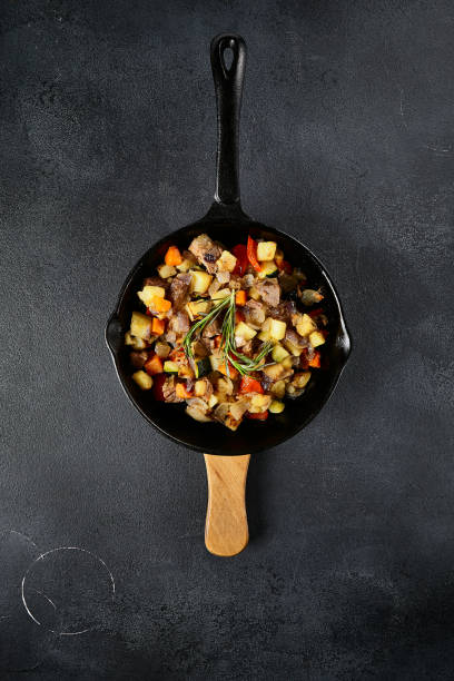 istock Top view of a hearty skillet beef ragout with mixed vegetables on a textured black backdrop 2142295567