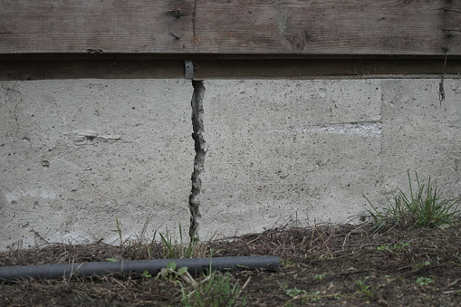 Close-up of a deep house foundation crack.